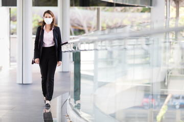 Woman wearing mask walking in city