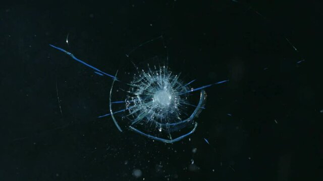 A bullet hitting bullet-proof glass - slow motion