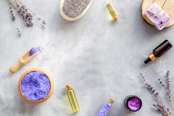 Obraz na płótnie Canvas Lavender spa set. Violet bath salt, essence oil on grey stone background