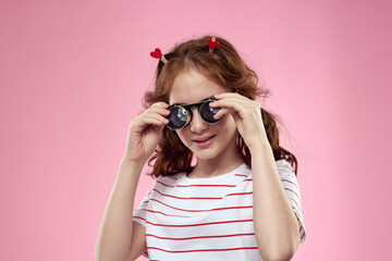 Cute girl sunglasses striped t-shirt lifestyle fun style pink background