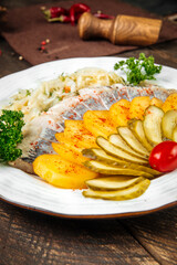 Russian appetizer with herring potato and pickles