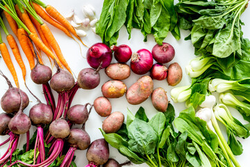 Carrot, potato, beet, onion and spinach on white background top view
