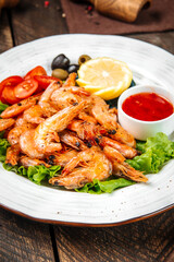 Roasted shrimps with lemon and red sauce