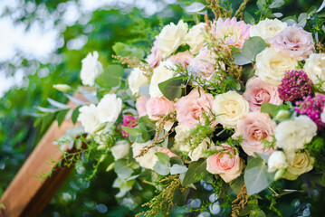 Fresh flower decoration of a wedding arch - pink and white fresh flowers. Fresh roses flower...