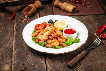 Roasted shrimps with lemon and red sauce