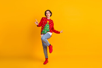 Full body photo of positive energetic girl in christmas tree decor pullover dance on x-mas tradition masquerade party isolated over bright shine color background