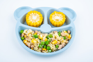 Nutritional meal for children on a plate on white background