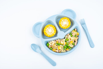 Nutritional meal for children on a plate on white background