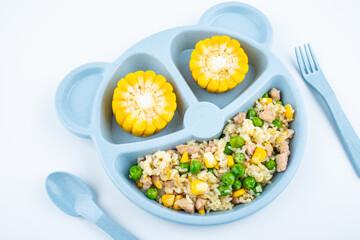 Nutritional meal for children on a plate on white background