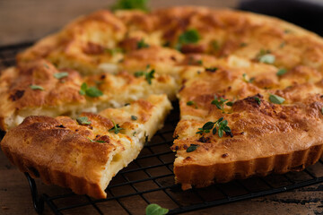 Pie or tart with feta cheese on wooden background.