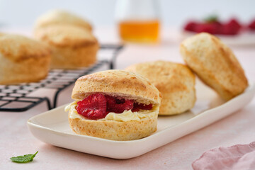 Traditional British Scones with clotted cream, raspberry jam. Scones with raspberry jam