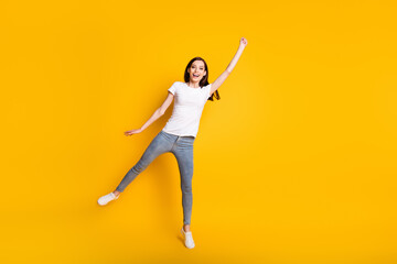 Full length body size view of her she pretty funky childish cheerful cheery lean girl jumping holding invisible parasol having fun isolated bright vivid shine vibrant yellow color background