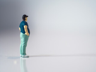 Obraz premium Miniature people, Fat man looks at tuna mayonnaise and crab sticks mayonnaise on white background