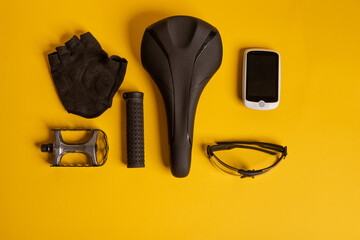 Bicycle, Cycling accessories on the yellow background. view from above.