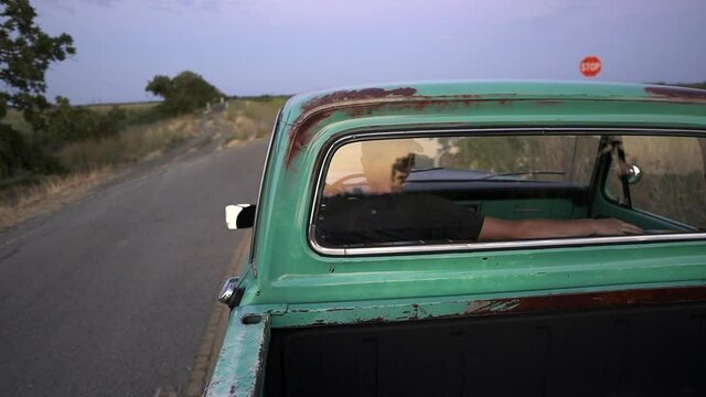 A dusk drive in a vintage truck on a country road.