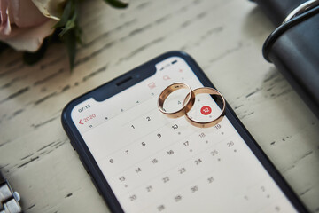 Wedding rings lie on the phone. Different accessories of businessman for creating style of  people...