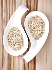 Uncooked brown rice in elegant bowls.