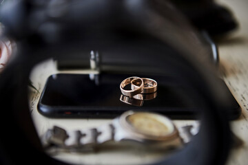 Wedding rings lie on the phone. Different accessories of businessman for creating style of  people...