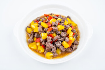 Diced beef with bell pepper on a dish of home cooking on white background