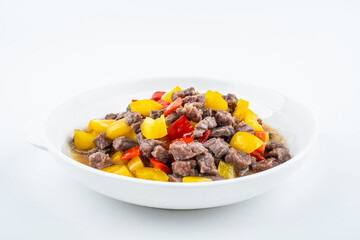 Diced beef with bell pepper on a dish of home cooking on white background