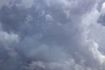 Small drone in a cloudy sky o the Atherton Tableland in Tropical North Queensland, Australia