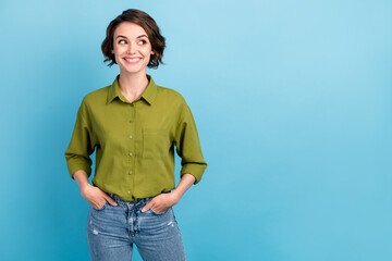 Photo of pretty self-assured lady short hairdo interested look side empty space hands pockets wear...