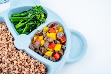 Nutritional meal for children on a plate on white background