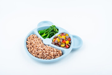 Nutritional meal for children on a plate on white background