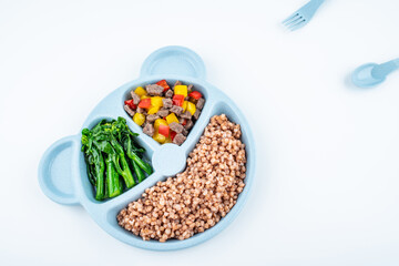 Nutritional meal for children on a plate on white background