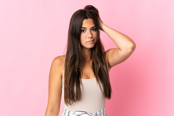 Young brazilian woman isolated on pink background with an expression of frustration and not understanding