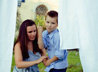 happy family making laundry outside, children helping