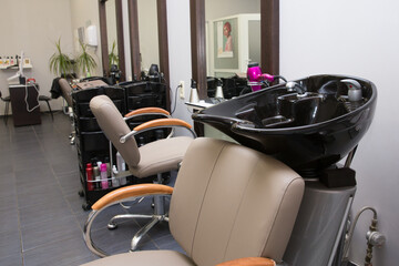 Hairdressing room with chair on the mirror.
