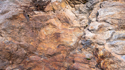 Rusted texture. Rusted background. Granite rocks. Colorful Rock background. Old Cracked Rusty Rough texture. Rock wall backdrop with rough red brown texture. Grunge Abstract Stone Surface.
