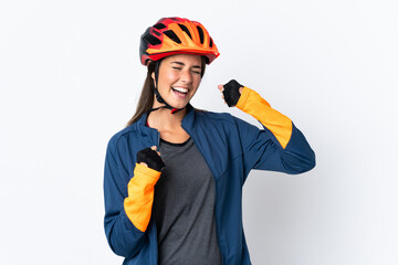 Young cyclist brazilian girl isolated on white  background celebrating a victory