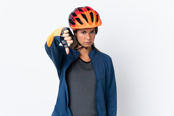 Young cyclist brazilian girl isolated on white  background showing thumb down with negative expression