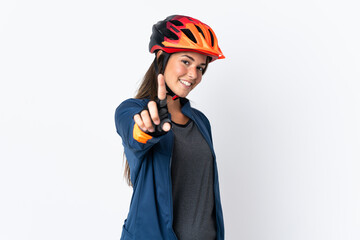 Young cyclist brazilian girl isolated on white  background showing and lifting a finger