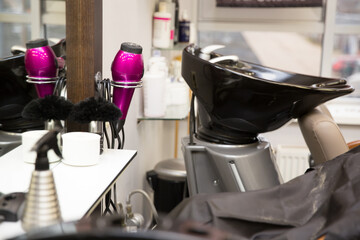 Hairdressing room with chair on the mirror.