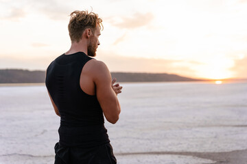 Image of caucasian athletic sportsman standing while working out