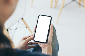 cell phone mockup blank white screen.woman hand holding texting using mobile on desk at coffee shop.background empty space for advertise.work people contact marketing business,technology
