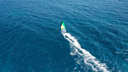 Obraz premium Aerial drone photo of wind surfer in open ocean deep blue sea on a windy morning