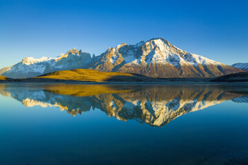 Perfect reflection of the Paine mountain range in Patagonia in a lake