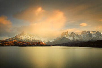 Fototapeta na wymiar Sunrise over the Paine mountain range in the Torres del Paine national park in Patagonia in South Chile.