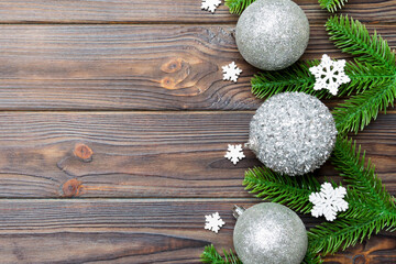 Obraz na płótnie Canvas Christmas composition made of fir tree, balls and different decorations on wooden background. Top view of New Year Advent concept with empty space for your design