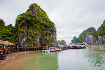 Fototapeta premium Tourist junks floating among limestone rocks at Ha Long Bay, South China Sea, Vietnam, Southeast Asia