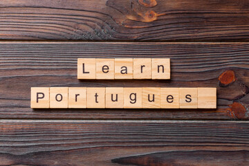 learn portuguese word written on wood block. learn portuguese text on table, concept
