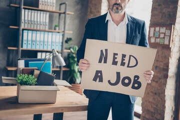 Cropped view portrait of his he serious jobless guy economist employer holding in hands placard...