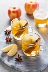 Apple cider cocktail with cinnamon and apple slices