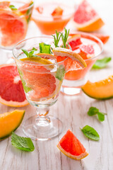 Refreshing infused water with pink grapefruit, cantaloupe melon and mint