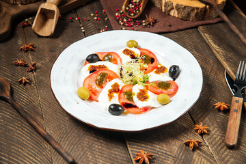 Side view on gourmet caprese salad in white plate
