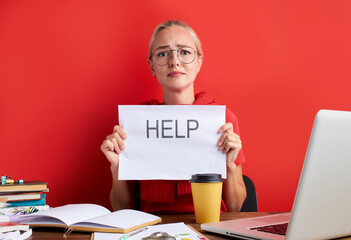 overworked unhappy and frustrated young caucasian woman in stress sitting at office desk, she has a...